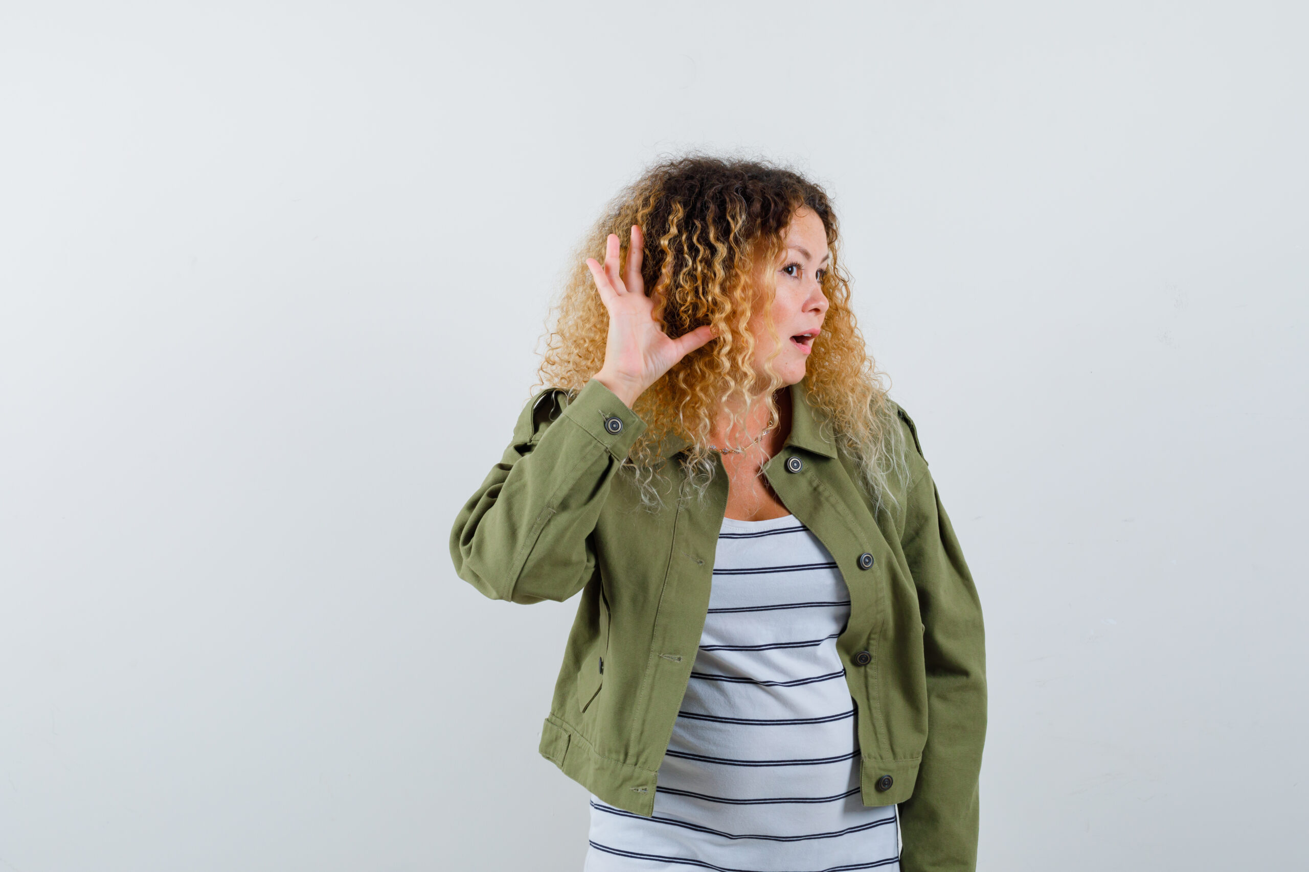 Woman listening for tips with open hand up to ear